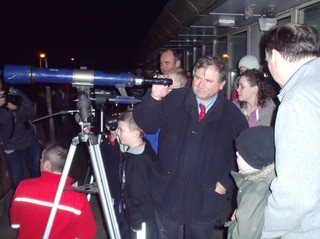 Professor Bailey showing the comet through a telescope