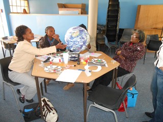 Educators using the Earth Ball to discuss distinguishing features of planet Earth