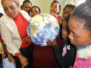 Learners pointing out Cape Town using the Earth Ball 