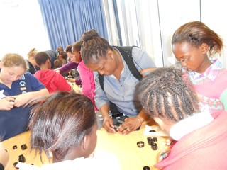 Zodwa, an educator from Lwandla Primary assisting children with their practical activities