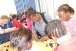 Zodwa, an educator from Lwandla Primary assisting children with their practical activities